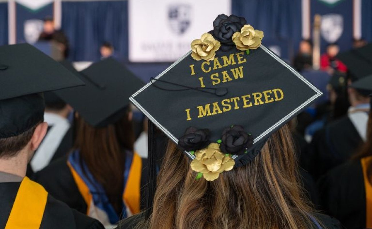 Mortarboard decorated with the phrase "I came. I saw. I Mastered."