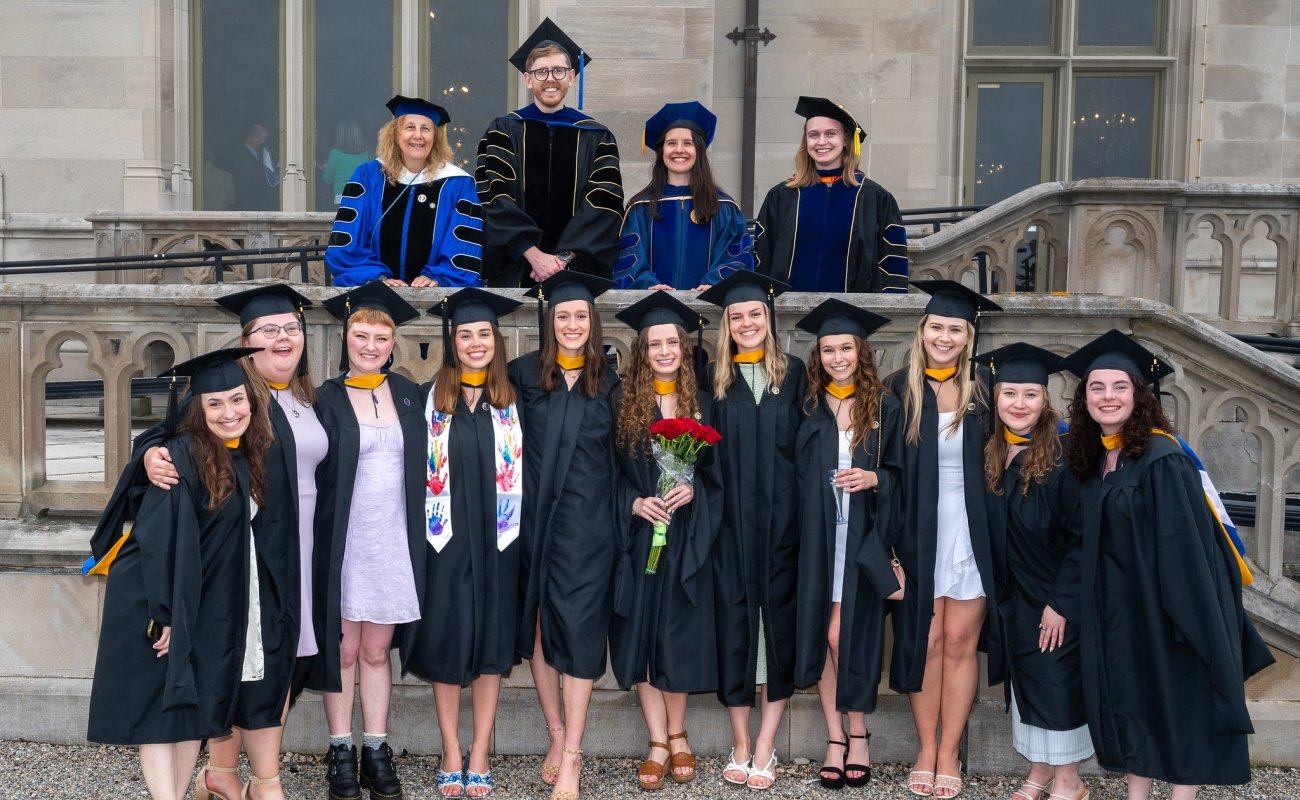 Group photo of behavior analysis graduates and their professors