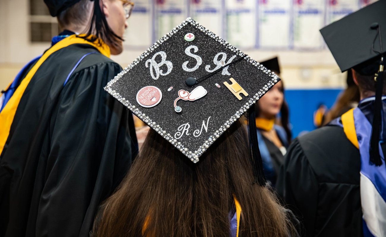 A decorated mortarboard that says "B.S.N./ RN"