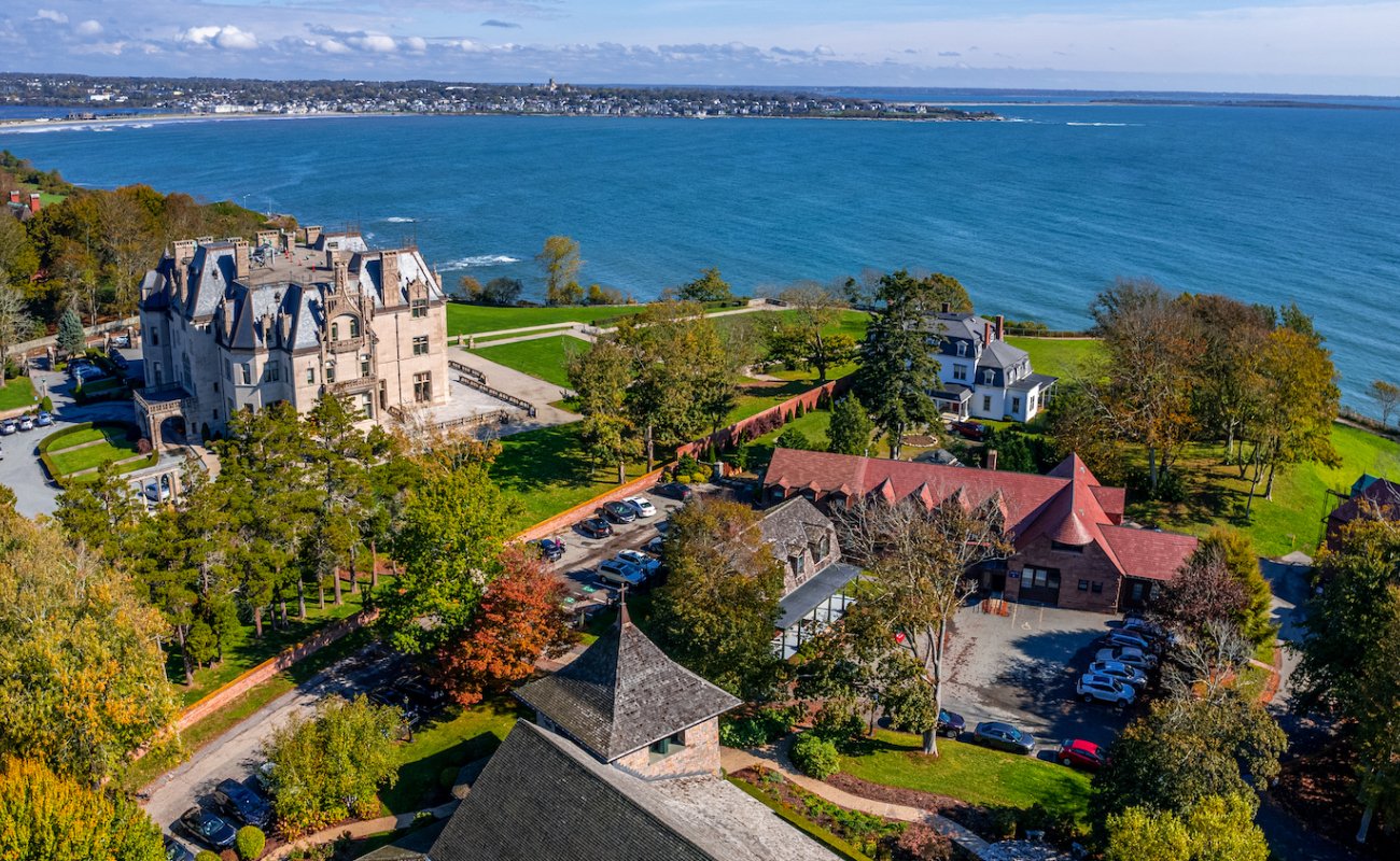 Drone shot of campus looking over McCauley hall with Ochre Court at west and water view beyond 