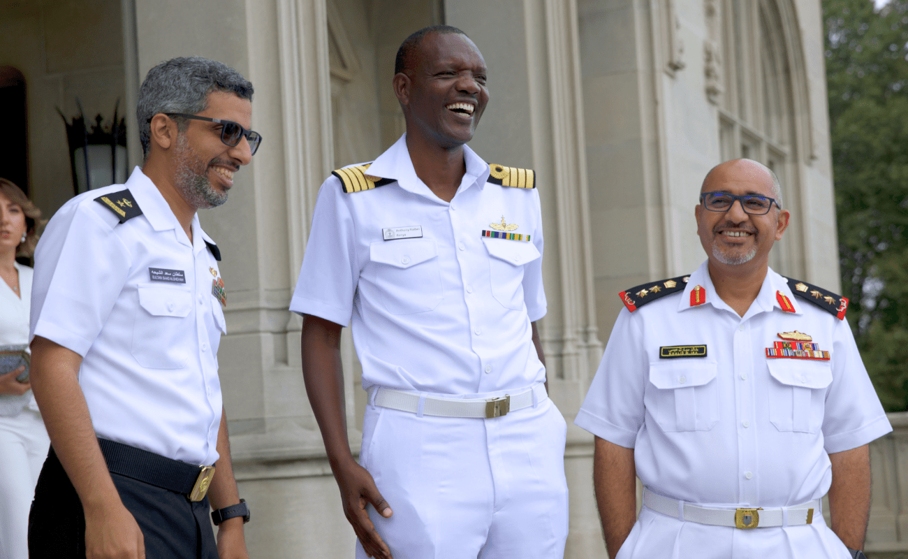 Three international navy war college students outside of Ochre Court laughing