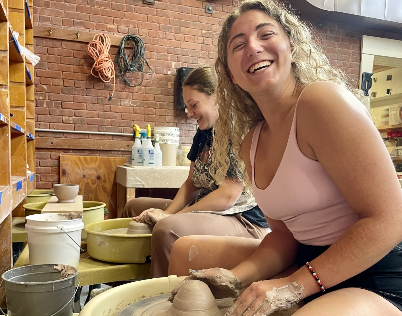 Girl sitting at a pottery wheel