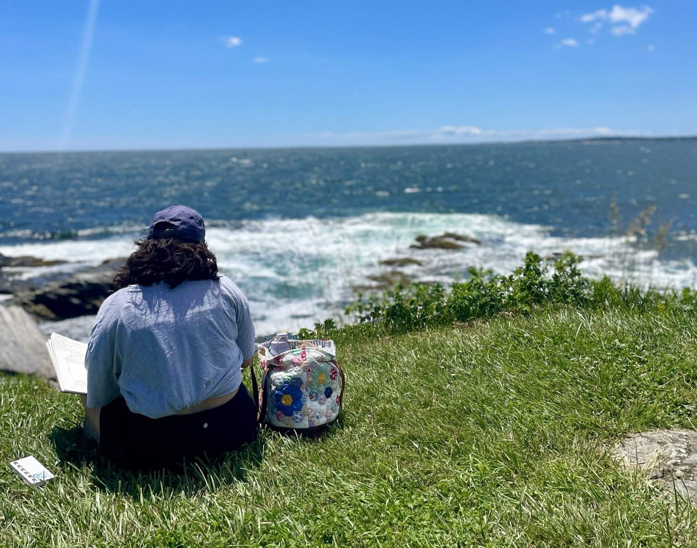 Girl sitting by the ocean