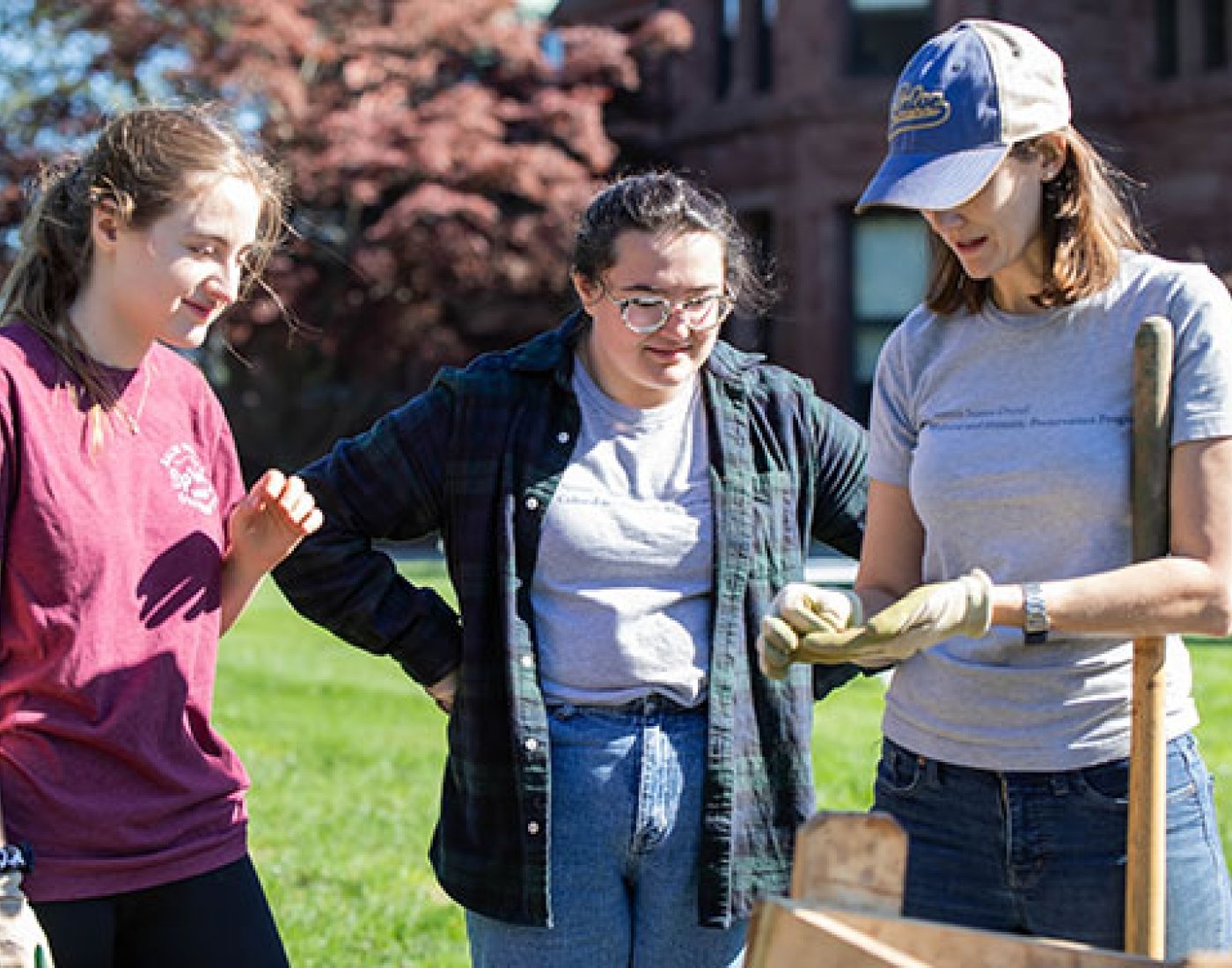 Students and a professor examining archaeological artifacts