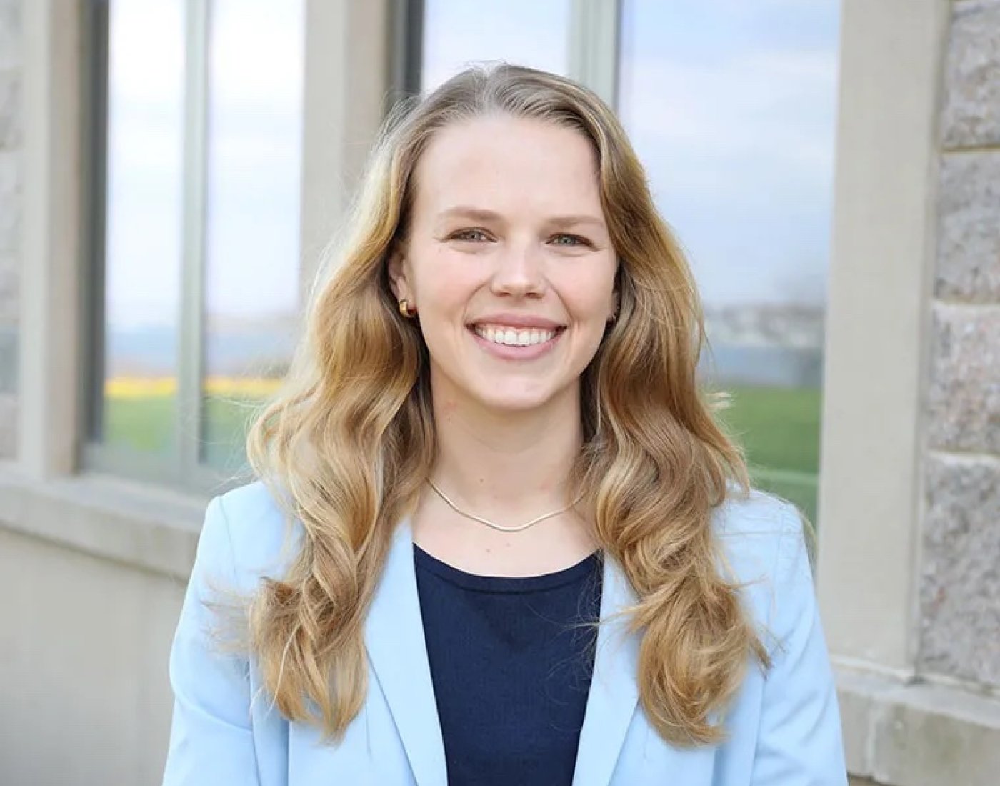 Professional photo of Dr. Teresa Starzecki smiling, standing outside of O'Hare academic building at Salve.