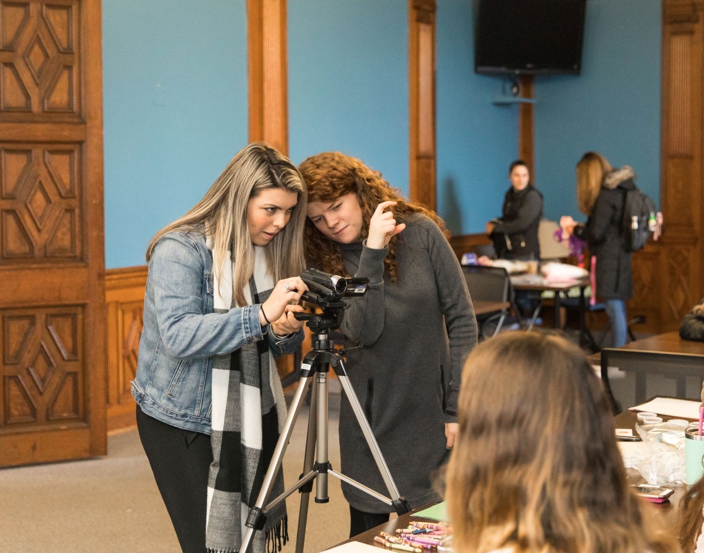students filming in historic campus building