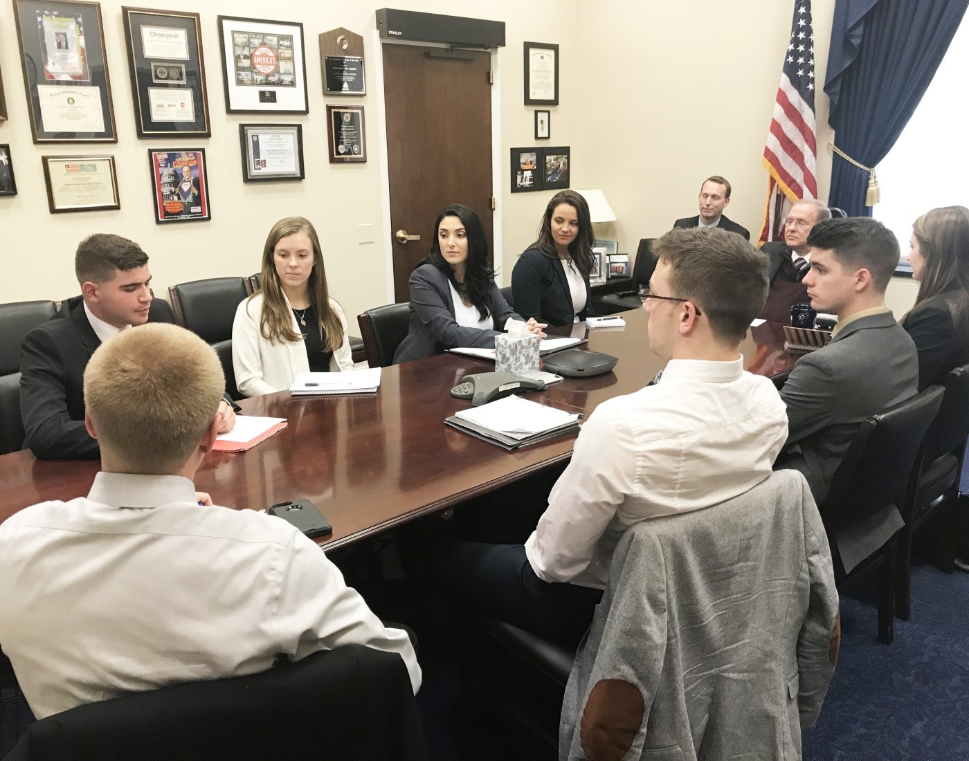 students around table in government office