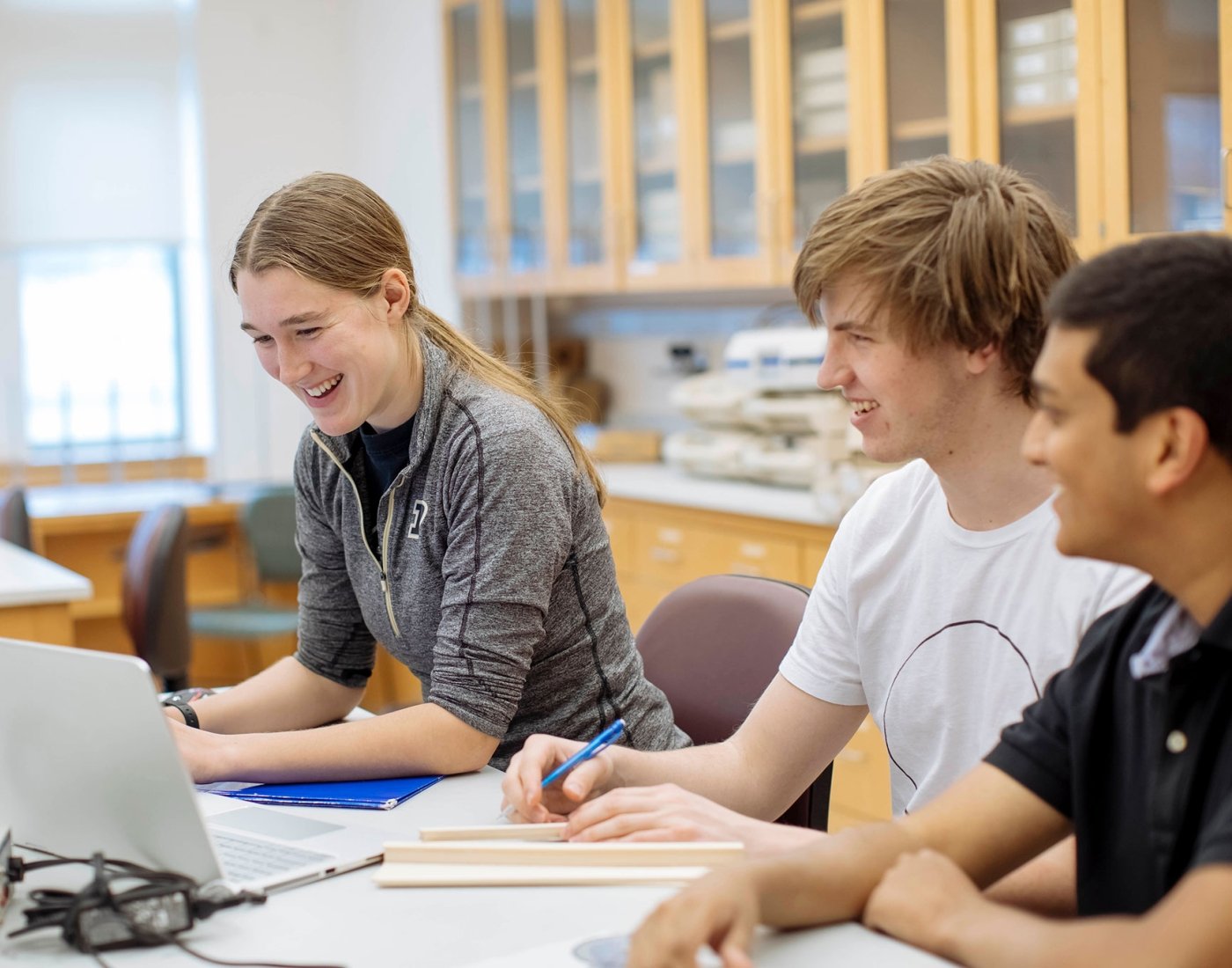 three students working at computer