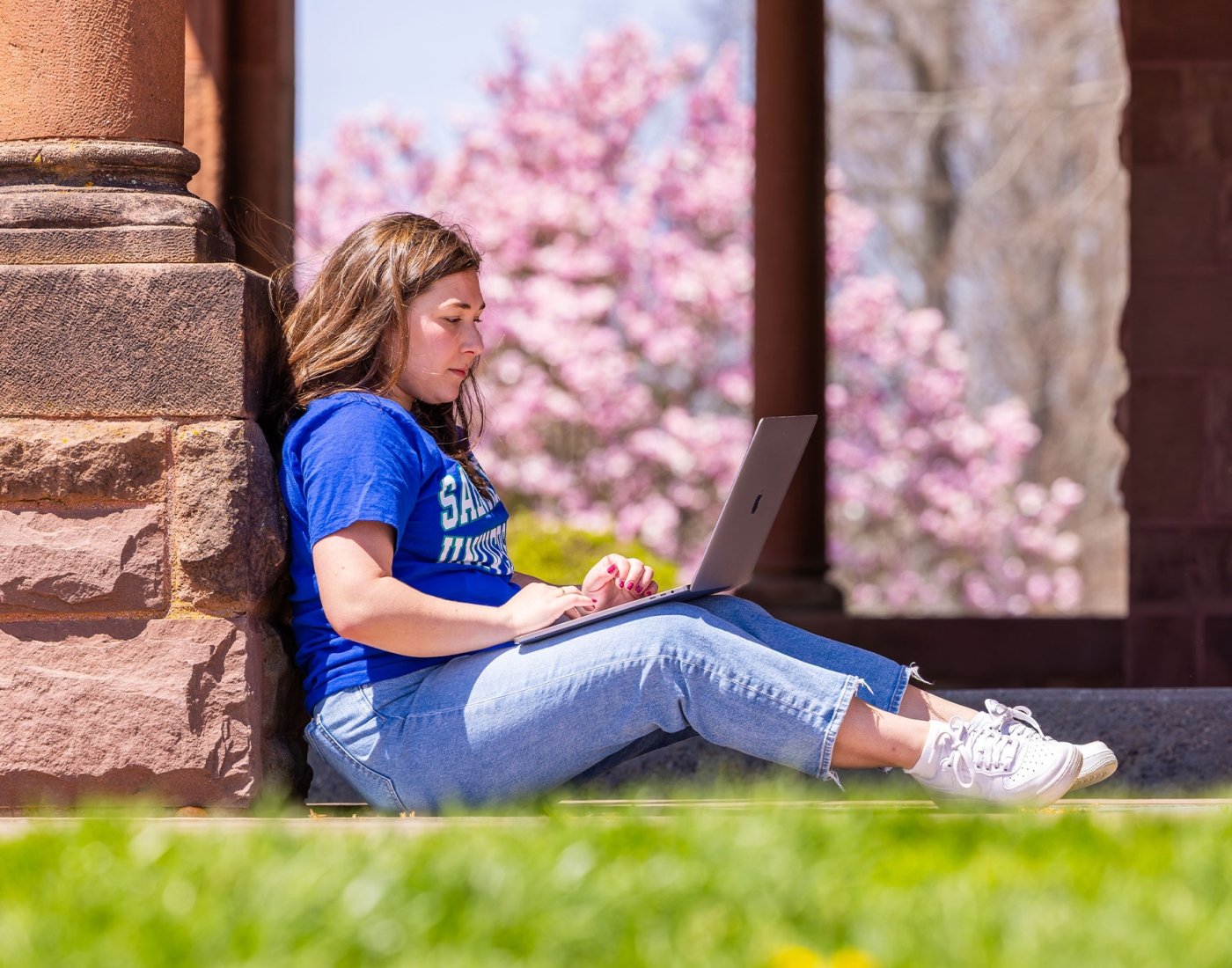 student working on laptop outside