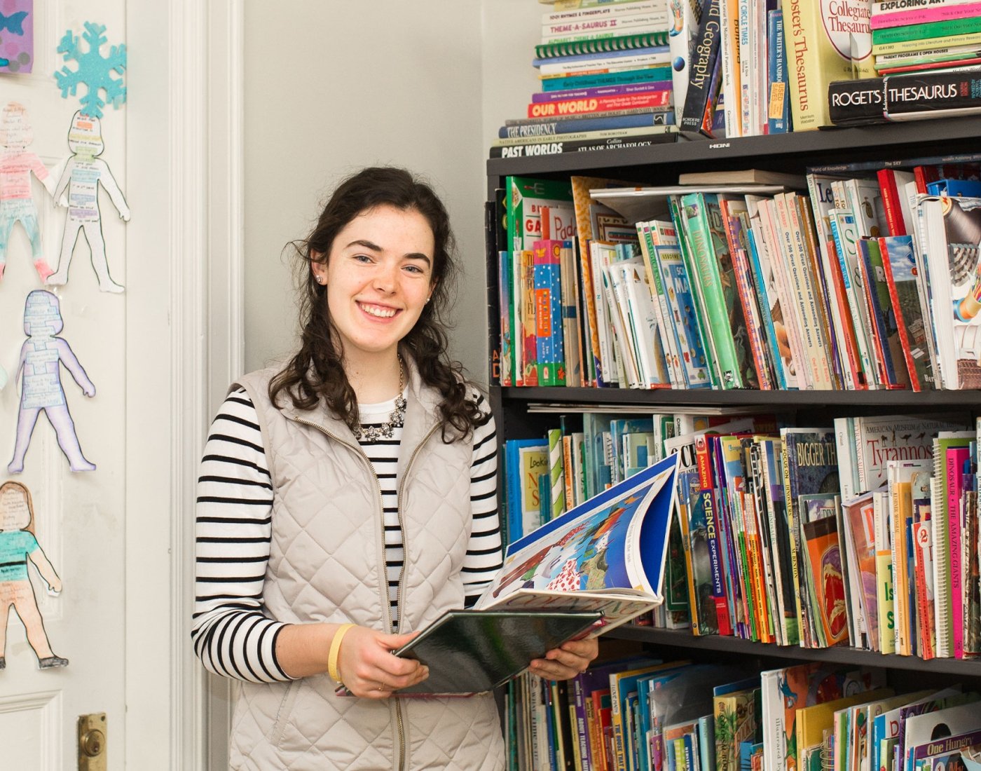 student posing with books