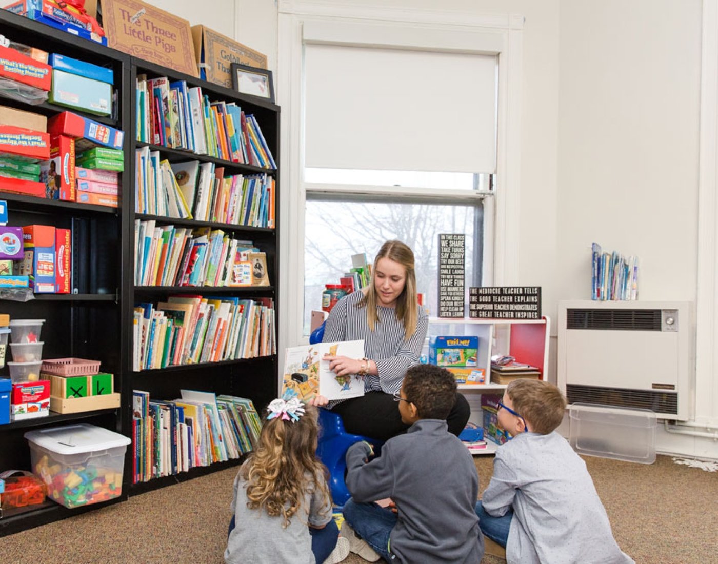 education student reading book to children