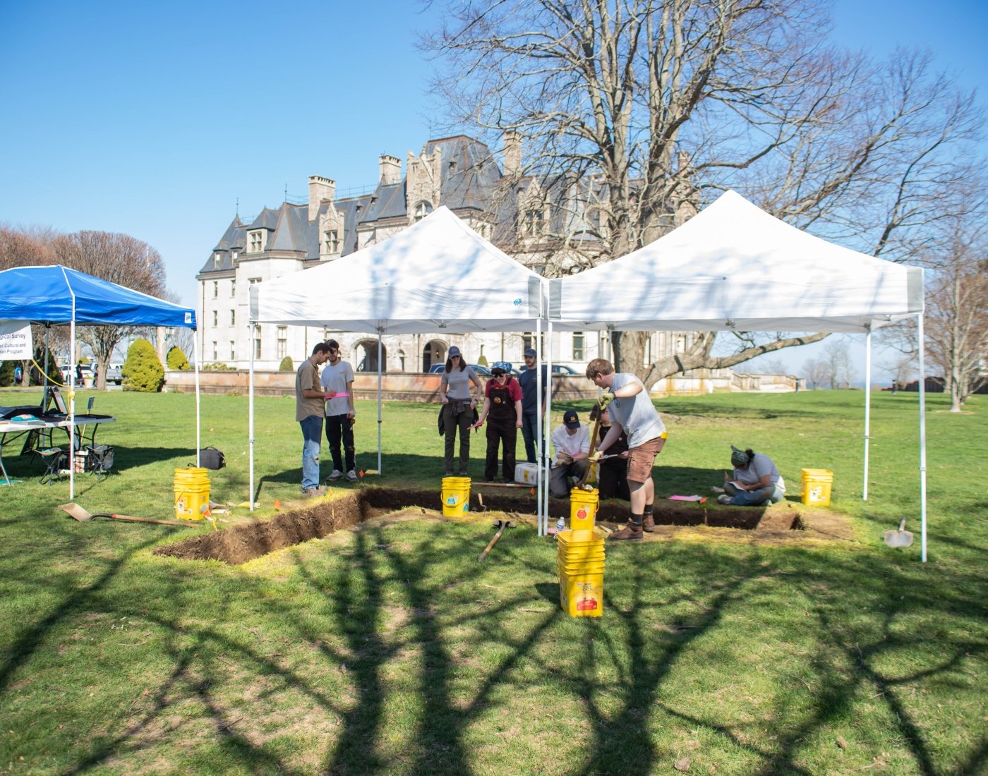 Faculty and students conduct an archaeological survey on the ground of Ochre Court.