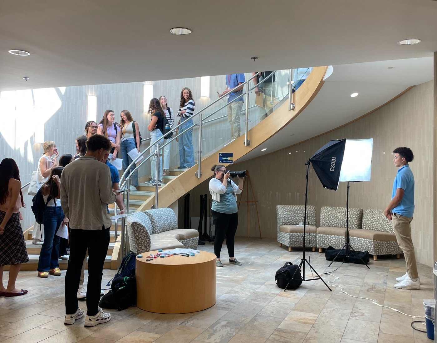 Student getting a professional headshot taken in a bright lobby