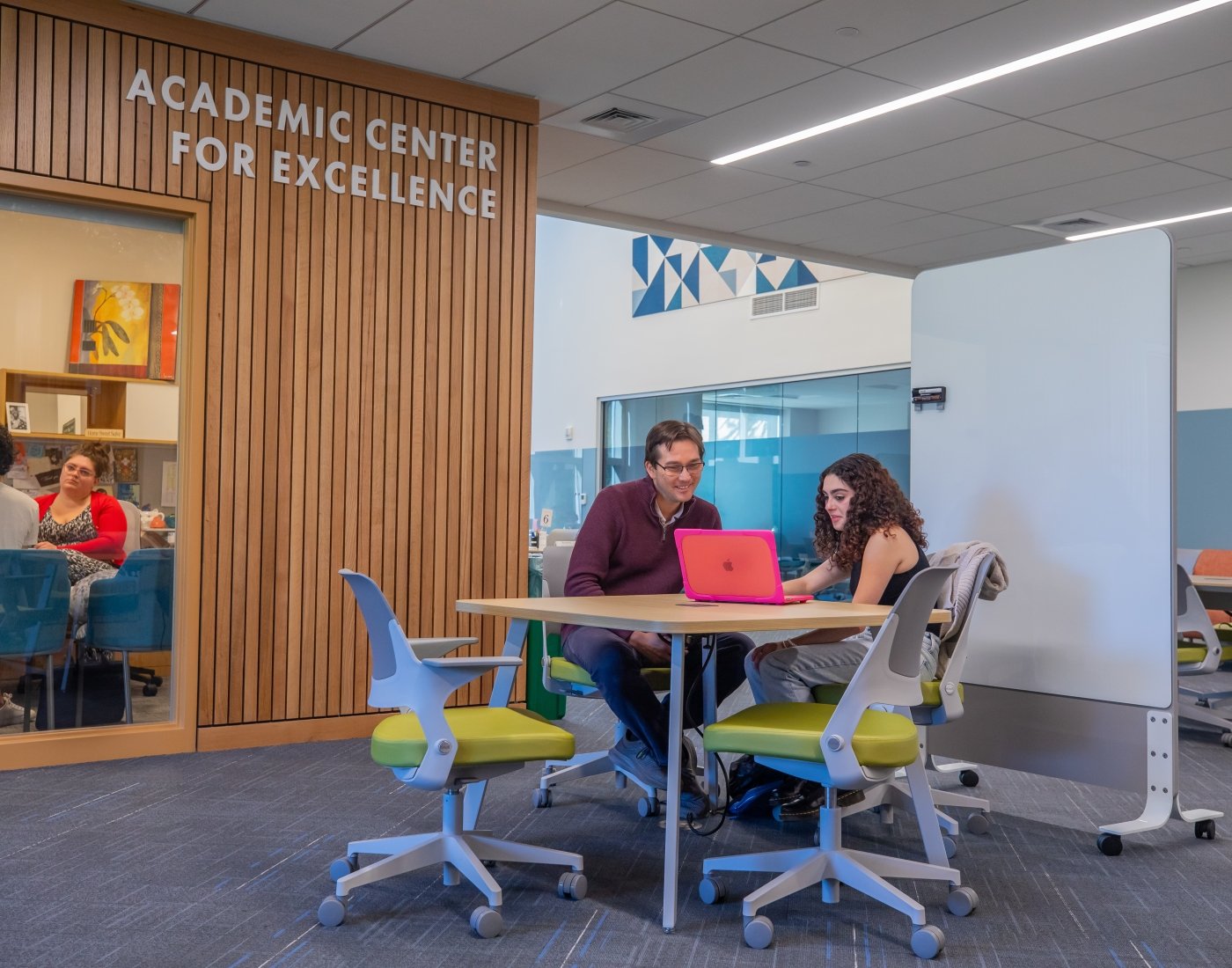 Writing Center staff member meets with student in McKillop Library.