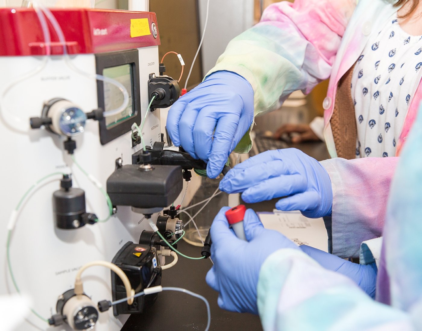 Students using chemistry instrumentation in a lab