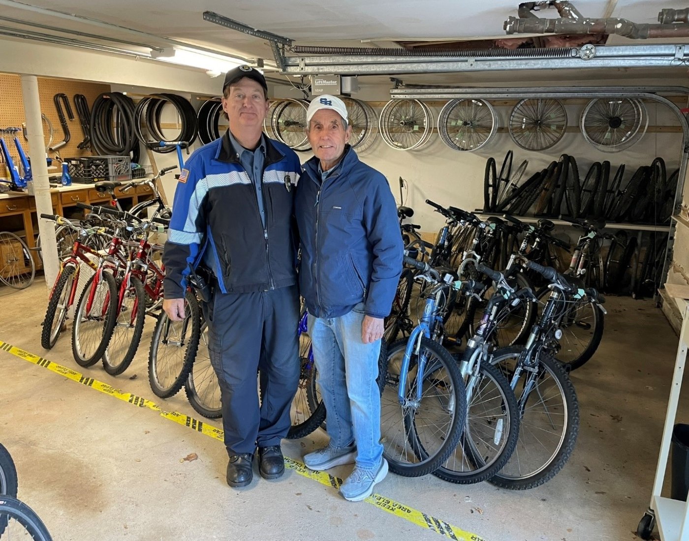 Two men standing in front of bicycles