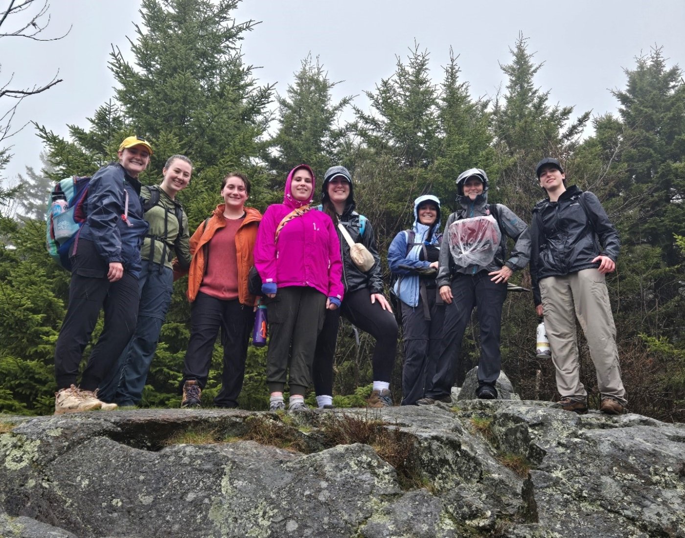 Group of people on top of a mountain