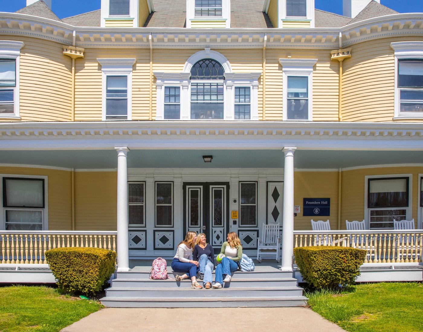students on porch Fouders Hall