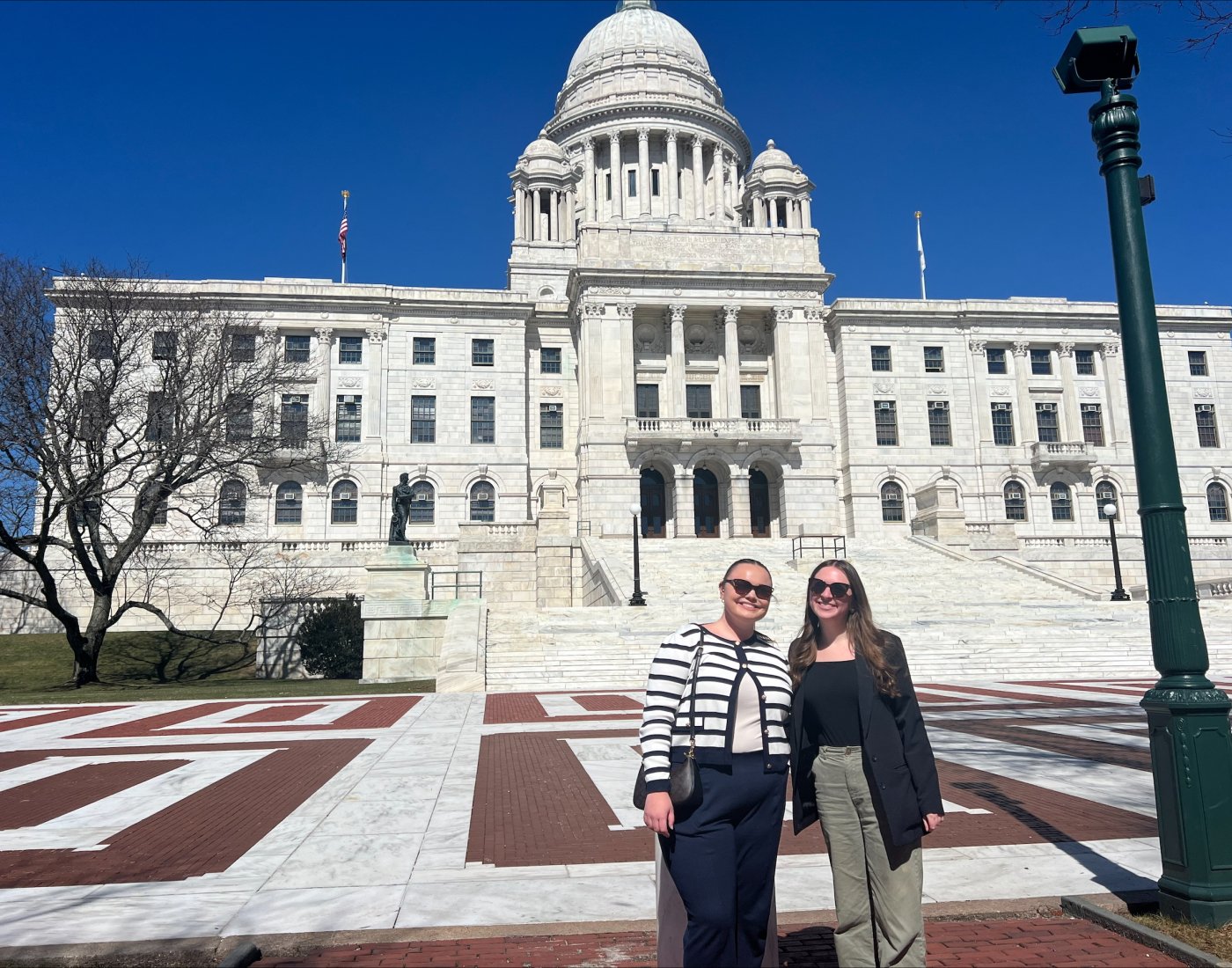 Two students standing outside of the RI State House