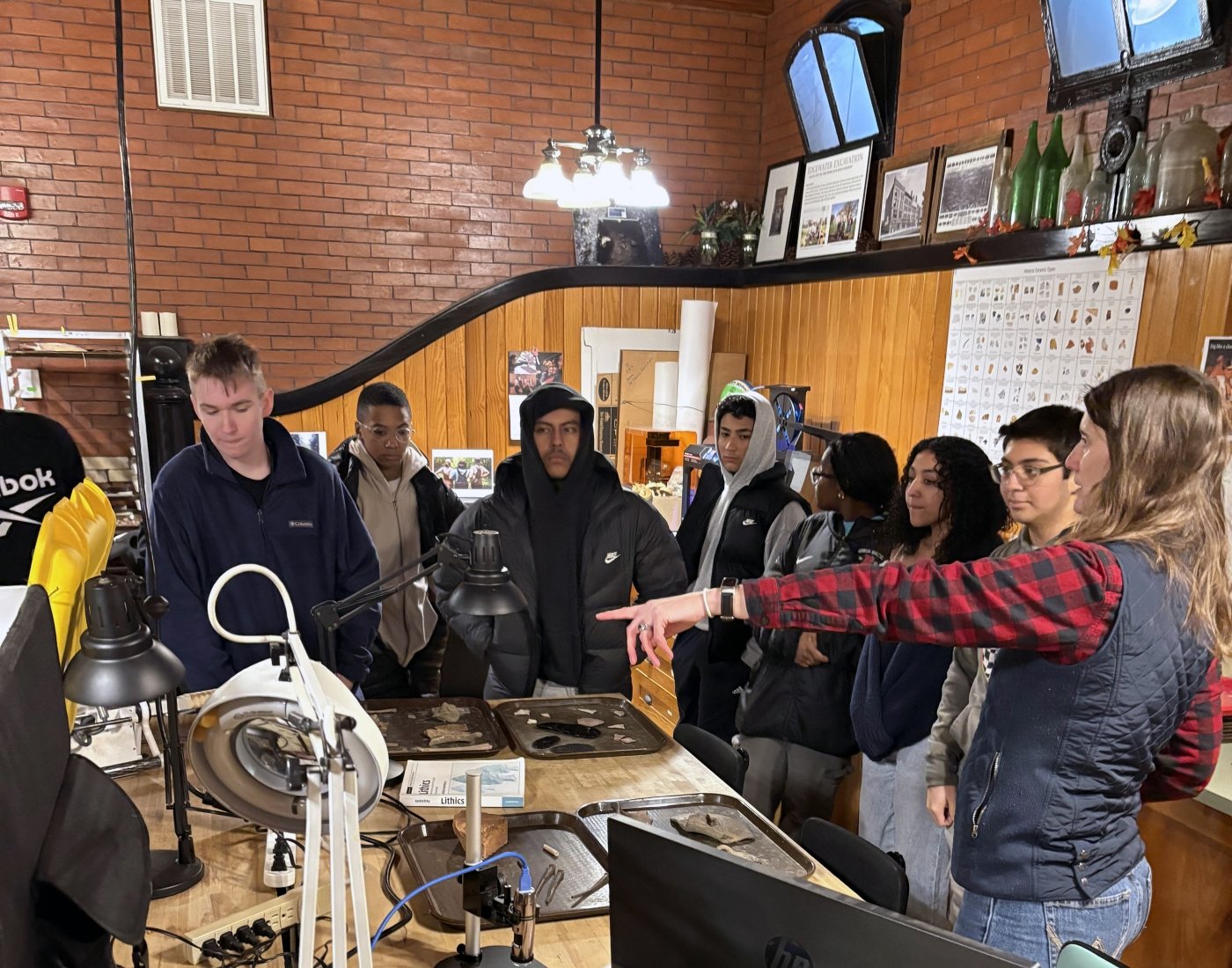 A woman speaking to a group of students in a laboratory