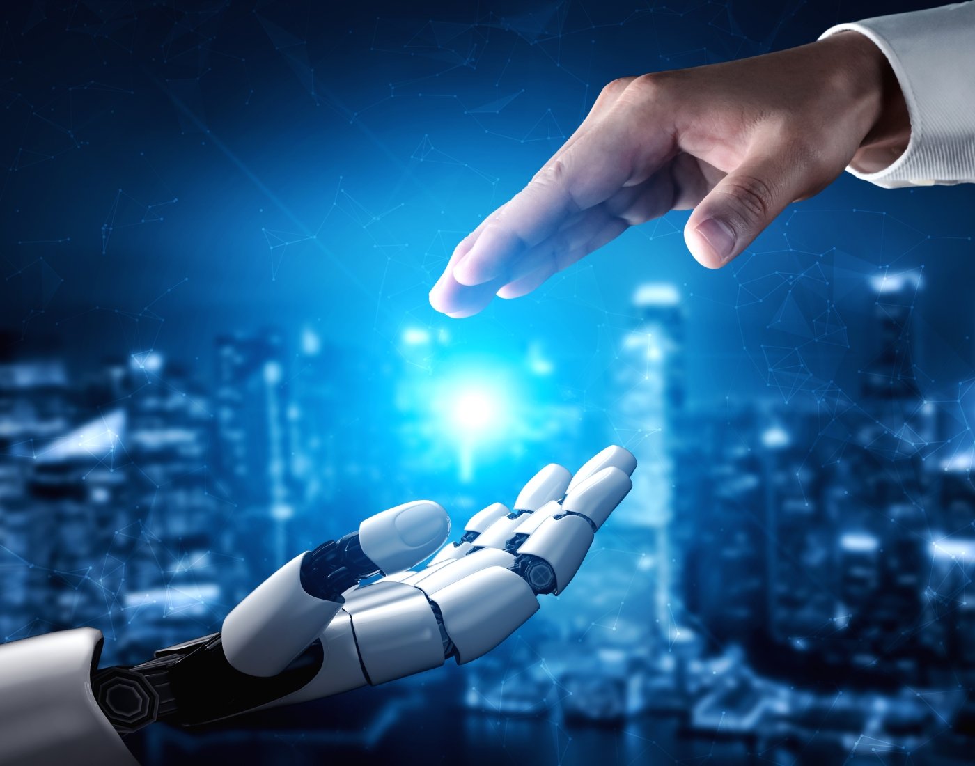 Human hand and robot hand reaching toward each other with futuristic blue background.
