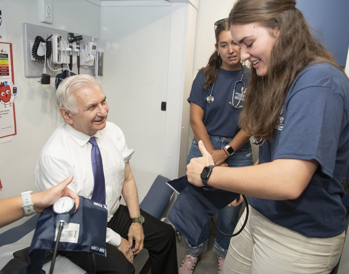 U.S. Senator Jack Reed learns the importance of preventative care from Salve Regina University nursing students in the school's new health and wellness educational mobile unit.