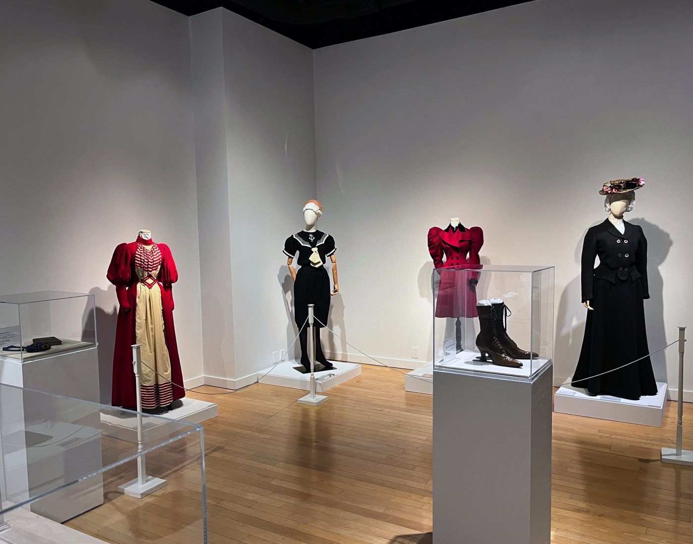 Late 19th century outfits on display in an art gallery