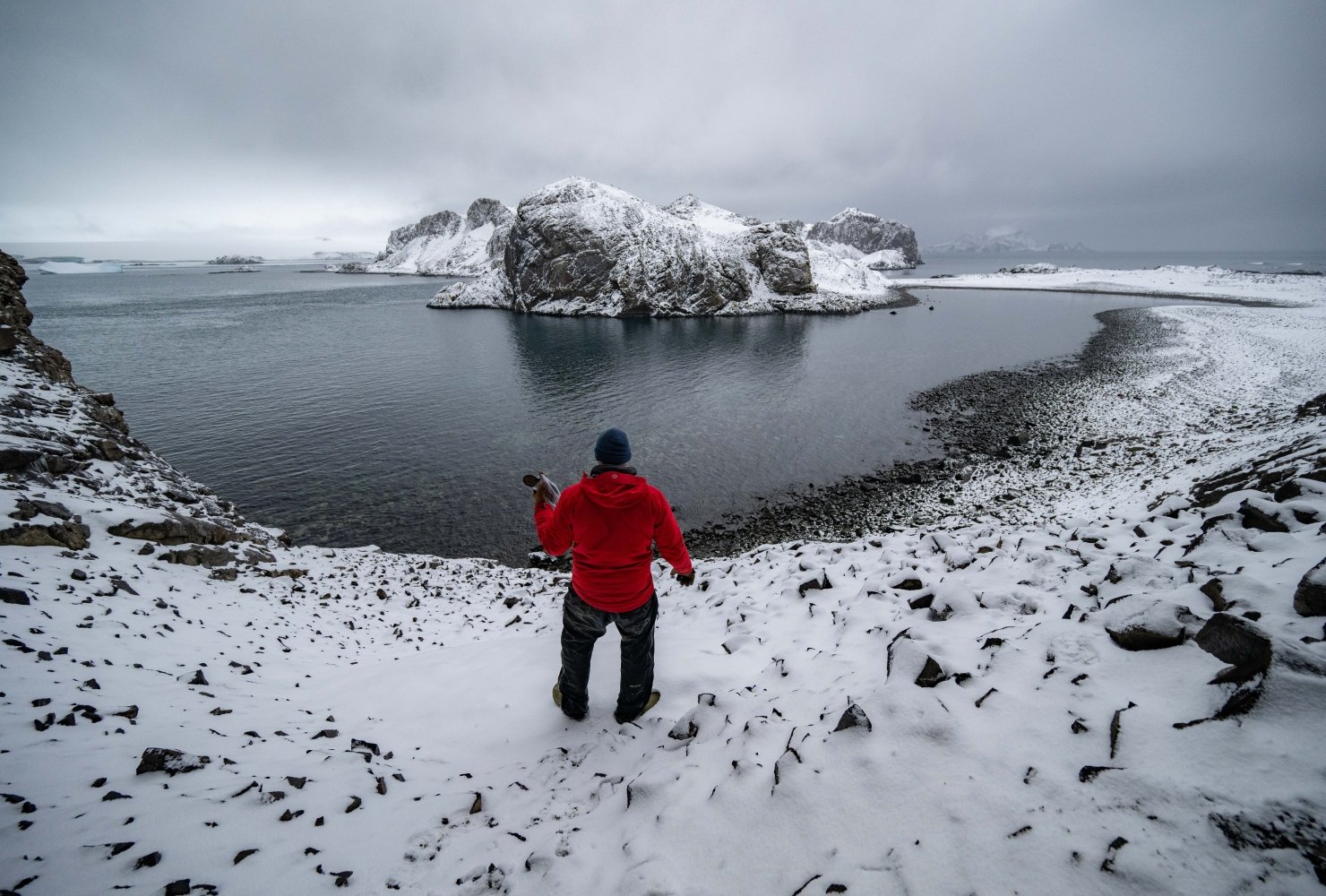 Kitchel carrying artifacts recovered from an 1820s seal hunter site on Cave Island.