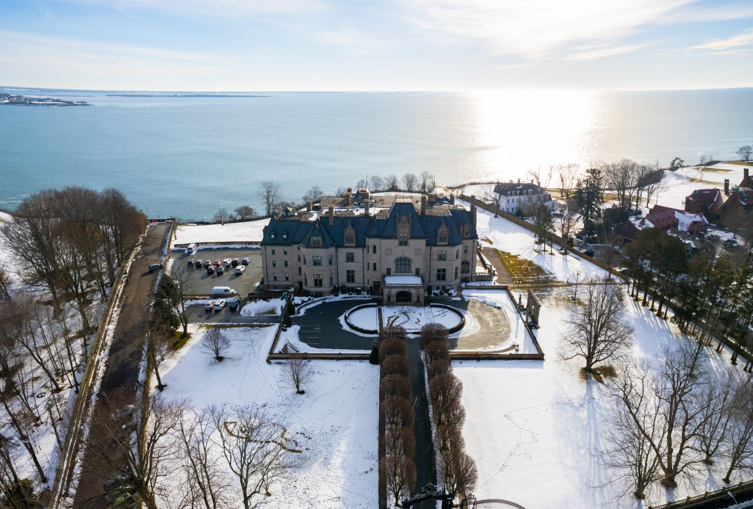 Drone shot of the exterior of Ochre Court in the winter with snow on the ground.
