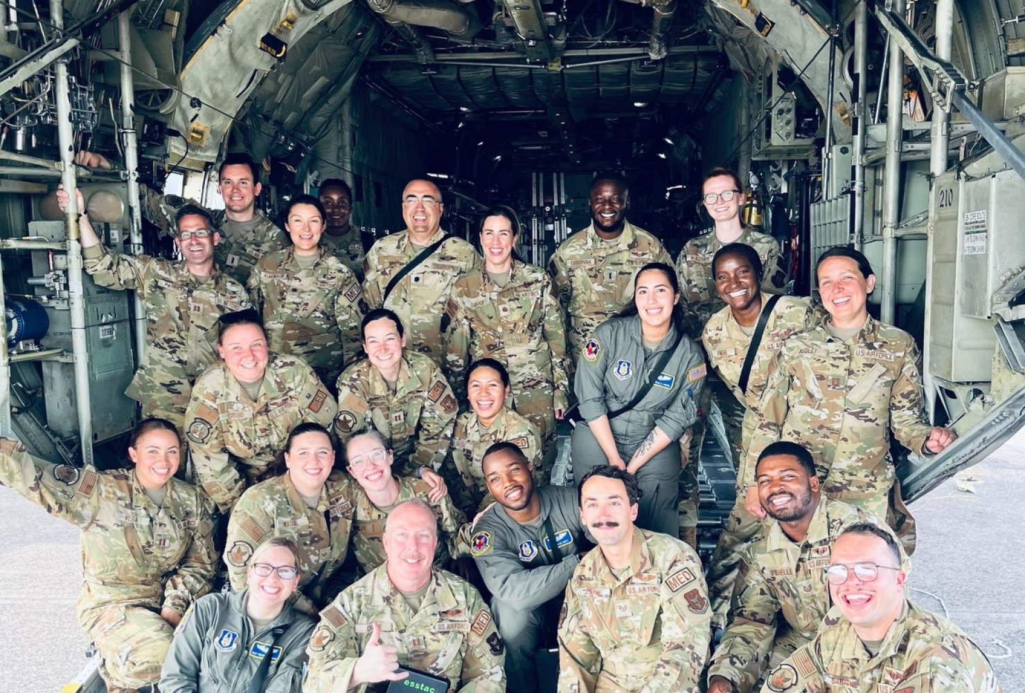 Group photo of Rose and other people in their Air Force uniforms on a plane.