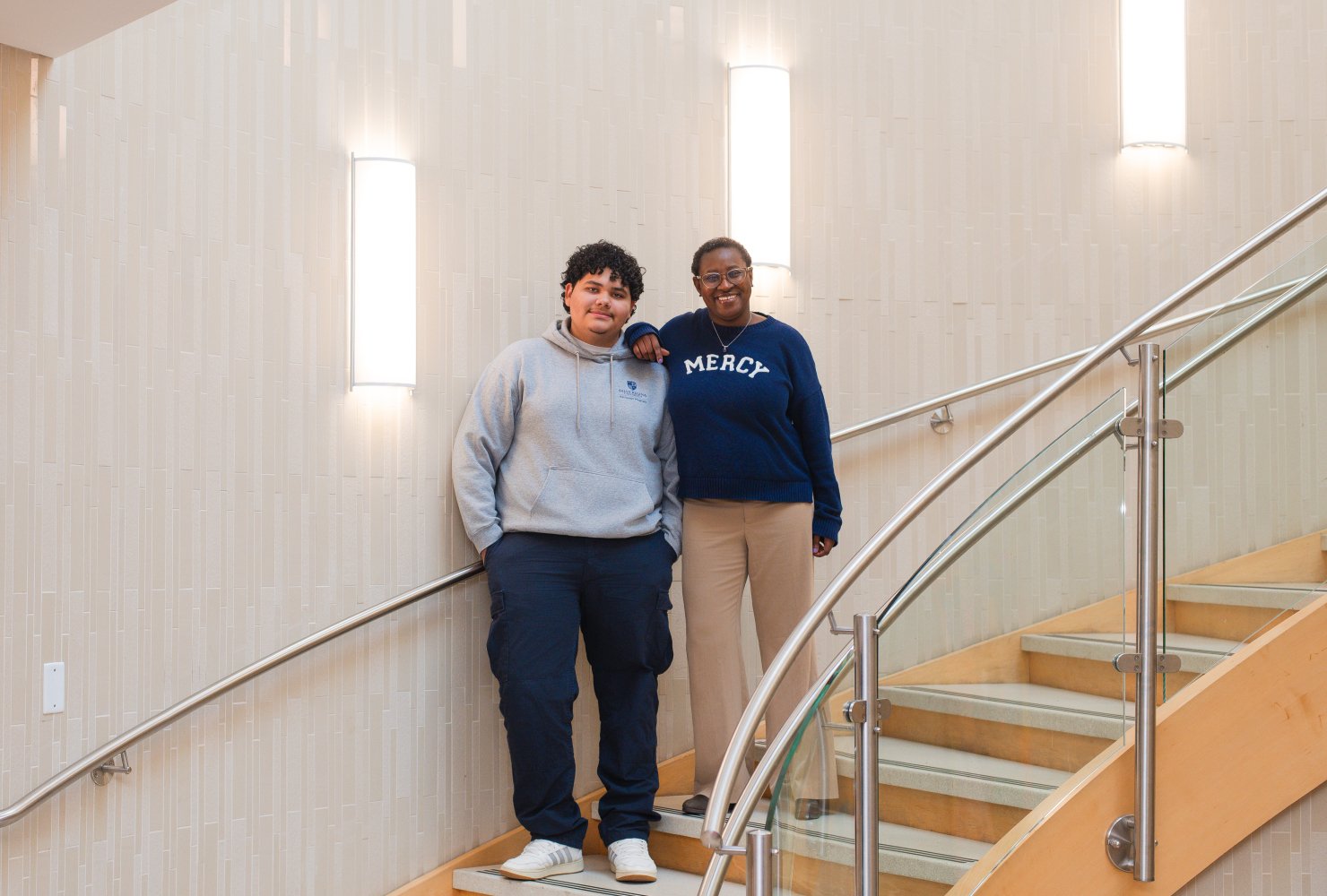 Aida and René posing for a professional photo on the stairs.