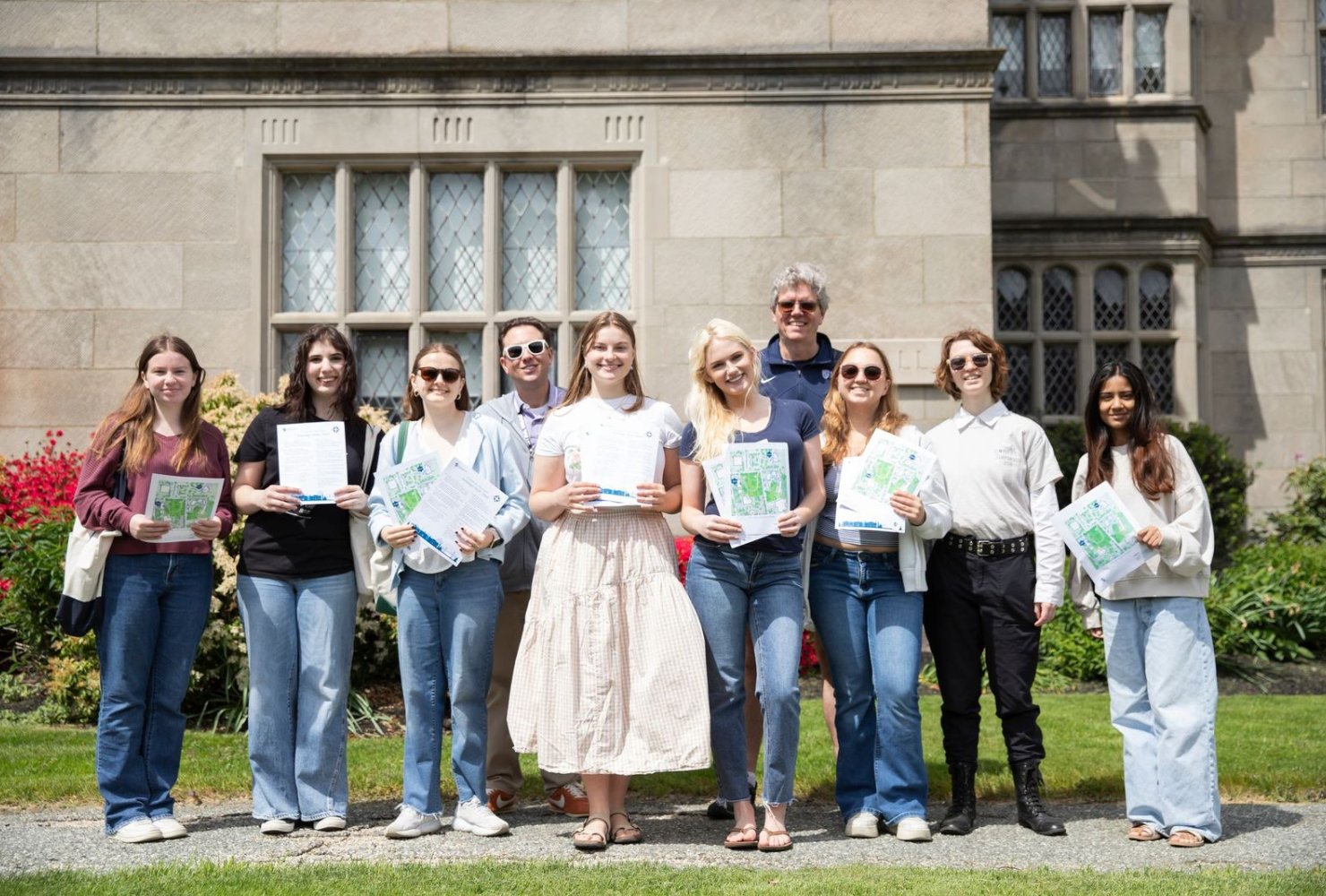 Group photo of the "Walking Through History" program students holding their scavenger hunts.
