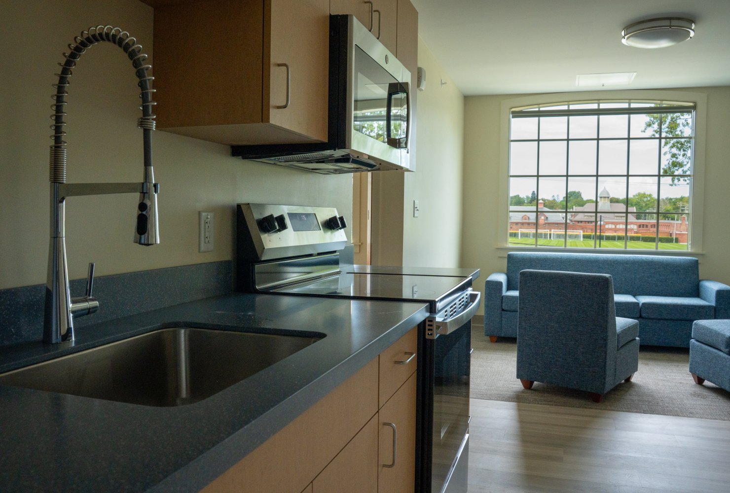 Inside residence hall kitchen and lounge with window