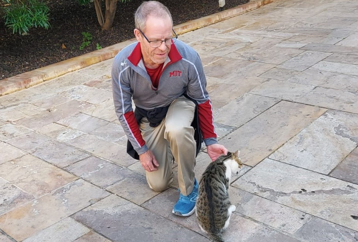Dr. Chad Raymond petting a cat in Jordan during sabbatical in 2024.