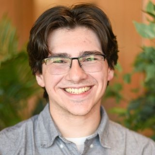 Male student smiling looking at camera