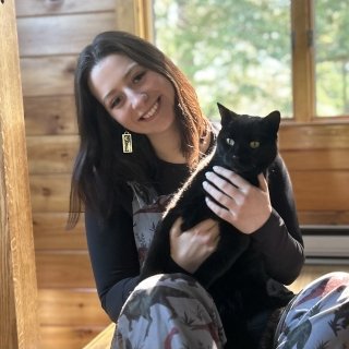 Photo of Jacqueline Wilson holding a black cat