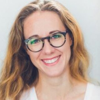headshot, blonde female wearing glasses