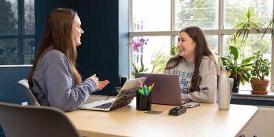 students tutoring in the library