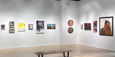An art gallery with white walls and paintings