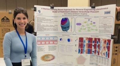 A female student presenting at a conference.