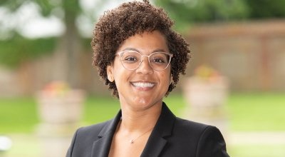 Close-up of a woman in glasses wearing a suit