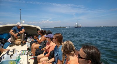 Students and faculty on a boat to Rose Island 