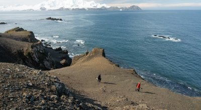 Dr. Jesse Casana (front) and Kitchel carrying survey equipment on Livingston Island.