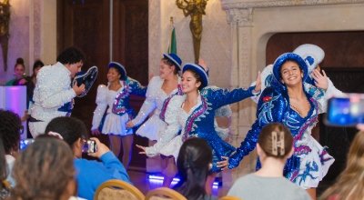 Dancers in sparkly blue and white outfits dancing in Ochre Court.
