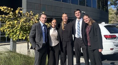 four students in business attire outside Siemens headquarters