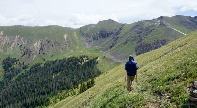 Dr. Jameson Chace hiking in the green mountains of Colorado.