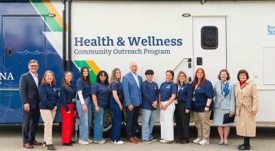 BankNewport, Harvard Pilgrim Health Care and Tufts Health Plan joining the Health and Wellness Community Outreach Program outside the mobile unit.
