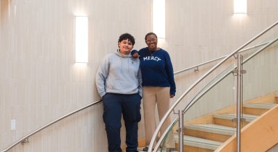 Aida and René posing for a professional photo on the stairs.