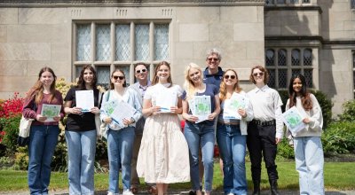 Group photo of the "Walking Through History" program students holding their scavenger hunts.