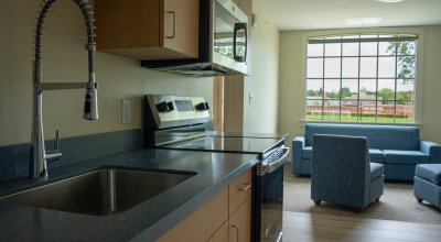 Inside residence hall kitchen and lounge with window